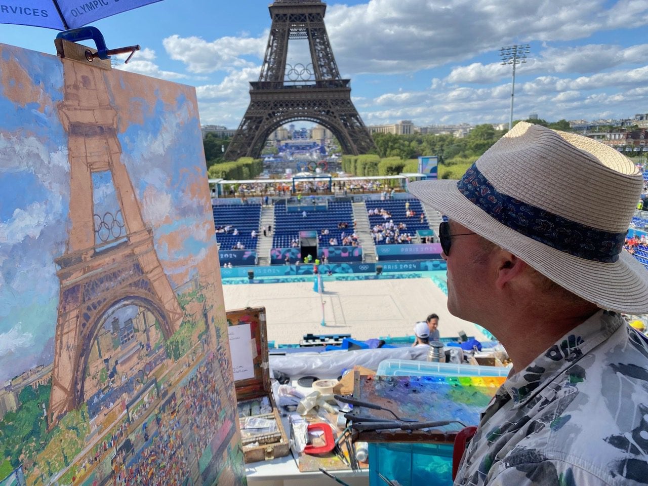 Peter Spens painting the Olympic beach volleyball at the foot of the Eiffel Tower during the Paris 2024 Games